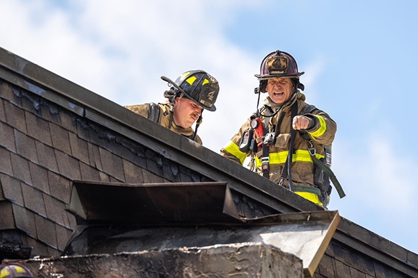 fire fighters working on roof