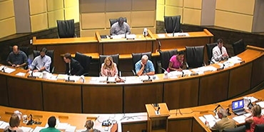 city council meeting live stream still showing citizen speaking to council