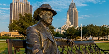 statue sitting in bench on the Mobile River