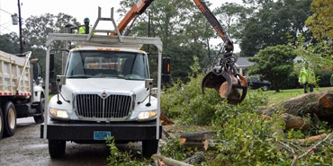 Garbage truck picking up trash at house