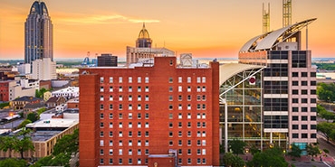 Downtown Mobile at sunset showing Government Plaza from side